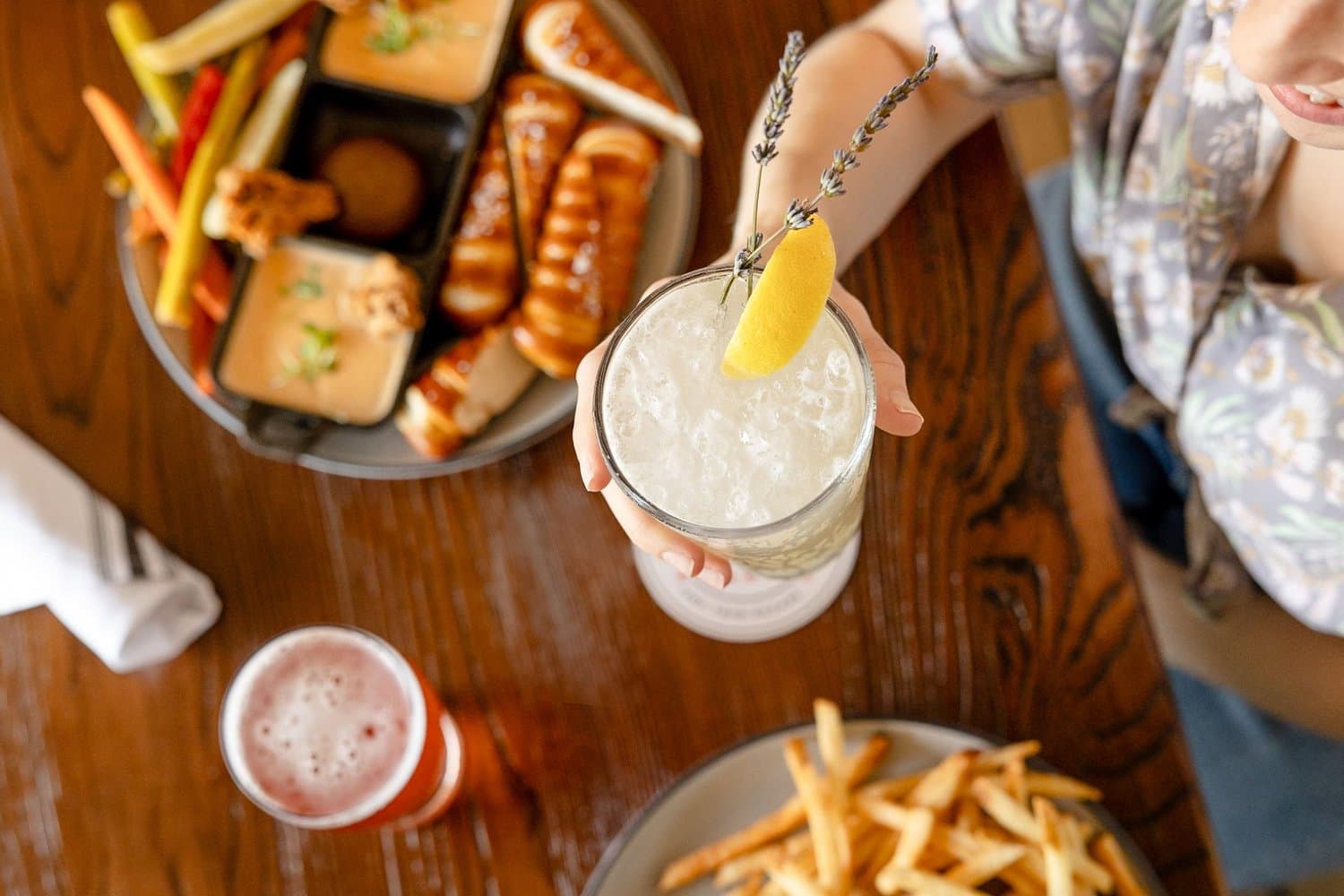 Food and drinks shared around a table at Hidden Wit